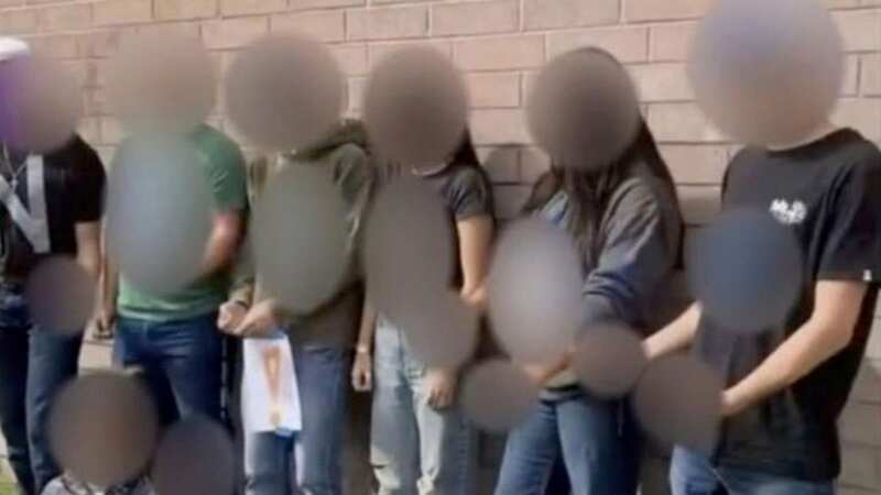 The students posed wearing shirts spelling out a racial slur as a mixed-race girl lay on the floor in front of them (Image: KTVB)