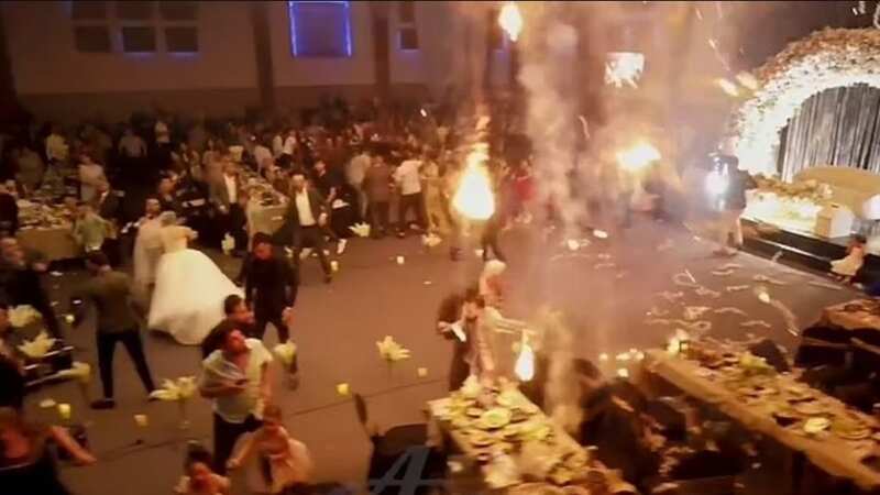 Building materials drop from the ceiling as a fire tears through a wedding reception in Iraq (Image: Twitter)