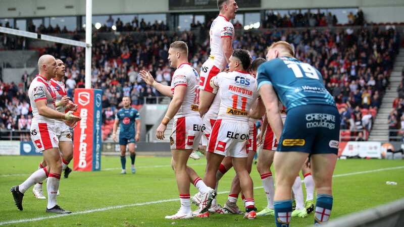 St Helens mob Tommy Makinson as he scores the crucial try in the play-offs win over Warrington Wolves (Image: Getty Images)