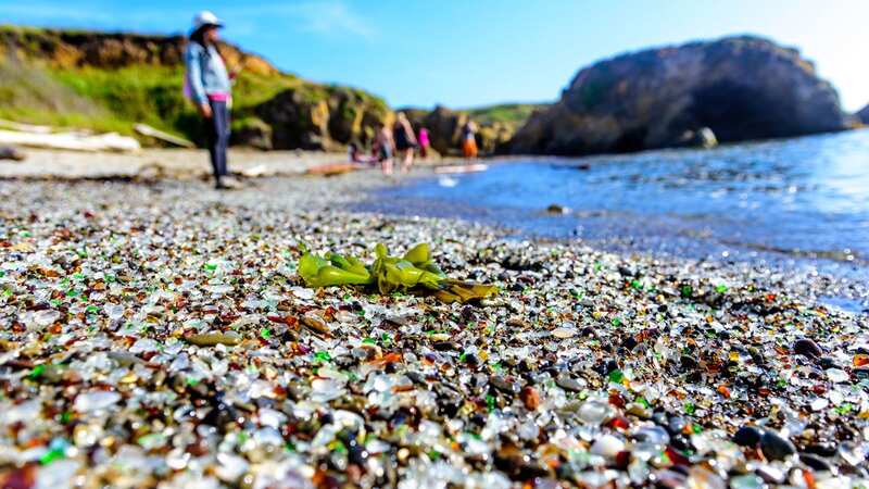 Rubbish ground down by the waves has made the beach glisten (Image: Getty Images)
