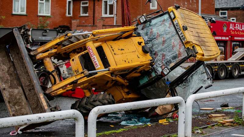 The digger that fell from the lorry in Bury (Image: William Lailey / SWNS)