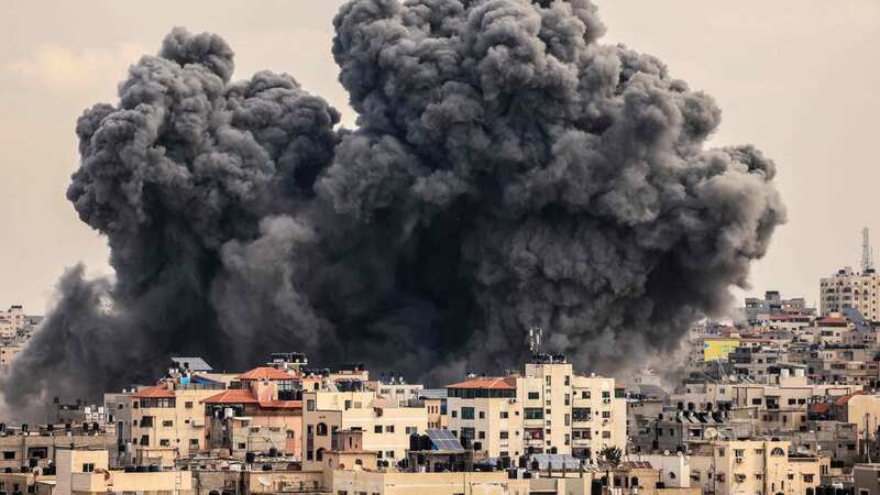 A plume of smoke rises in the sky of Gaza City during a separate Israeli airstrike (Image: AFP via Getty Images)