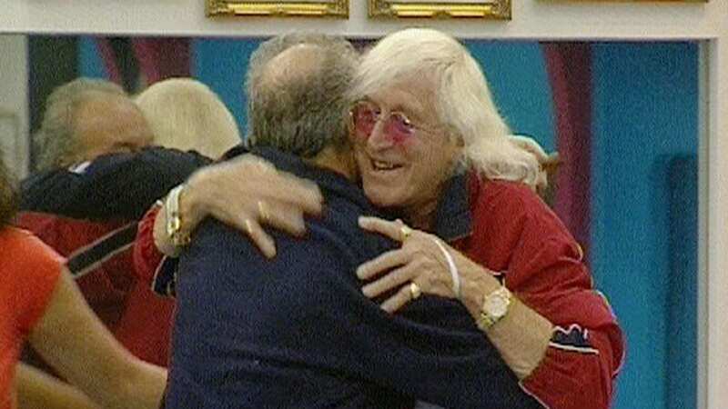 Jimmy Savile is greeted by George Galloway as he enters the house (Image: PA)