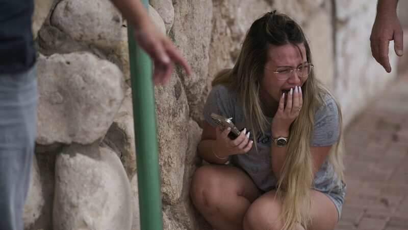 Israelis take cover from incoming rocket fire from the Gaza Strip in Ashkelon (Image: Getty)