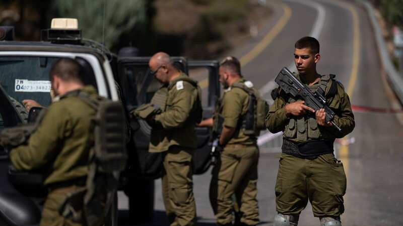Israeli soldiers guard a check point near the border with Lebanon (Image: AP)