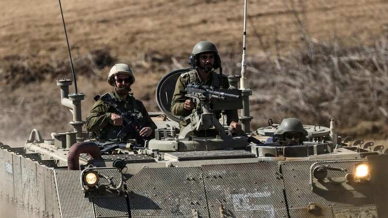 An Israeli armoured vehicle advancing towards the border with the Gaza Strip (Image: AFP via Getty Images)