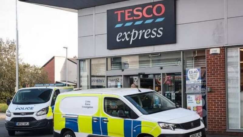 Forensics officers at the Tesco Express store (Image: MEN MEDIA)