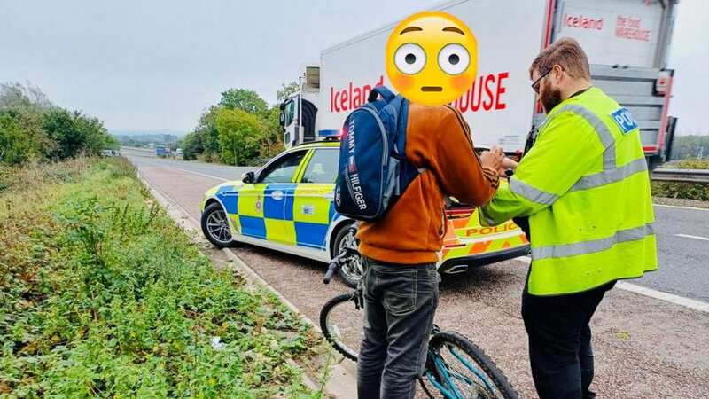The cyclist stopped by police after he rode his bike up the M4 (Image: Wiltshire Specialist Operations SWNS)
