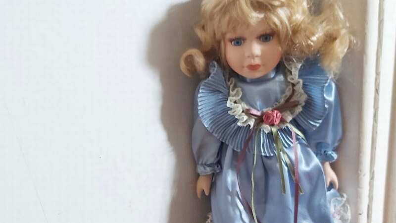 The unnamed doll is believed to have a demon living inside it and is for sale for £75 ($91.52) (Image: Ebay)