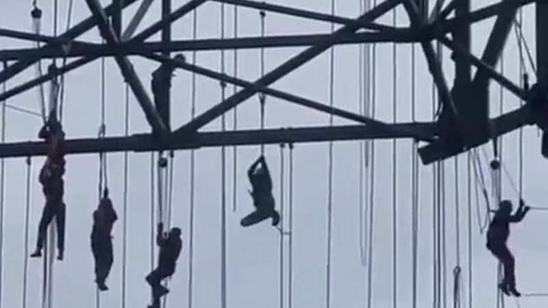 Moment scaffolding collapses leaves terrified workers dangling 500ft in the air