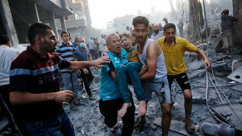 Injured girl is carried away after airstrike on Gaza Strip (Image: AFP via Getty Images)
