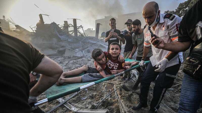 Wounded brothers are carried from the rubble after airstrike on Gaza (Image: MOHAMMED SABER/EPA-EFE/REX/Shutterstock)