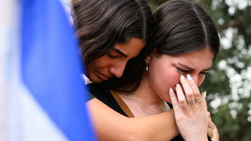 Young women weep for the dead in Israel (Image: Getty Images)