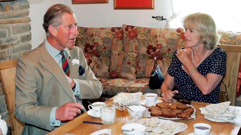 King Charles and Queen Camilla taking tea during a visit to Wales. The Royal Family may have money to burn but they are notoriously frugal (Image: Getty Images)