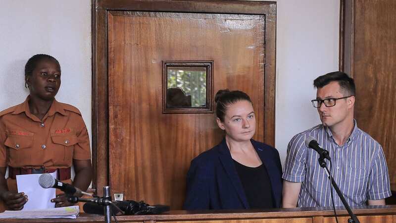 The pair stand in the dock at a court in Buganda (Image: AFP via Getty Images)