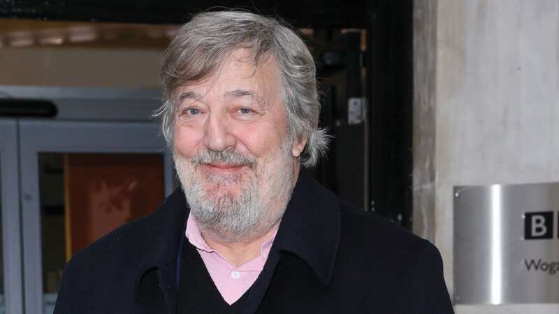 Stephen Fry seen with a walking stick as he