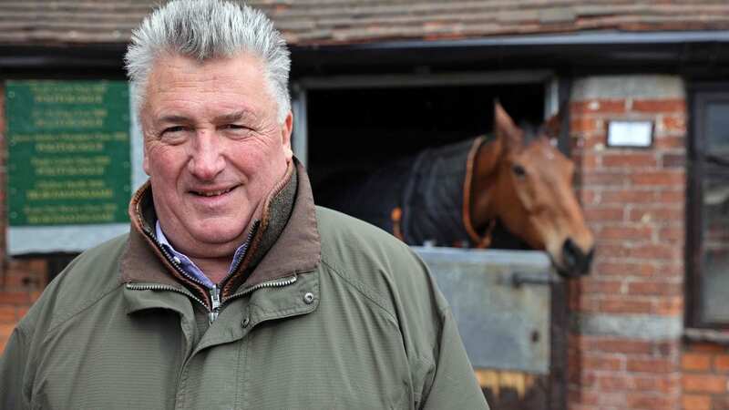 Racehorse trainer Paul Nicholls stands alongside Bravemansgame during a press day at his Manor Farm stables in Ditcheat near Shepton Mallet, south west England on February 27, 2023. - Bravemansgame is entered into the upcoming Cheltenham Gold Cup race. (Photo by Adrian DENNIS / AFP) (Photo by ADRIAN DENNIS/AFP via Getty Images)