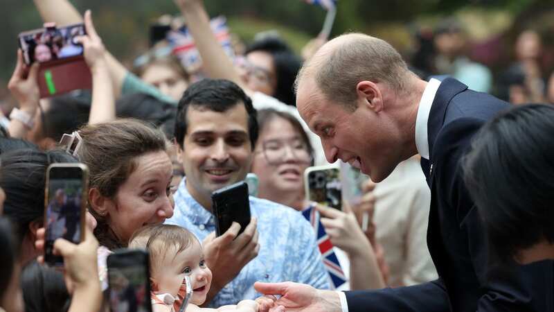 Cute moment baby sucks on Prince William