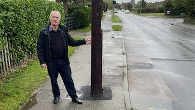 Steve Tragner, 72, beside the telecom pole that punctured a sewage pipeline (Image: Steve Tragner / SWNS)