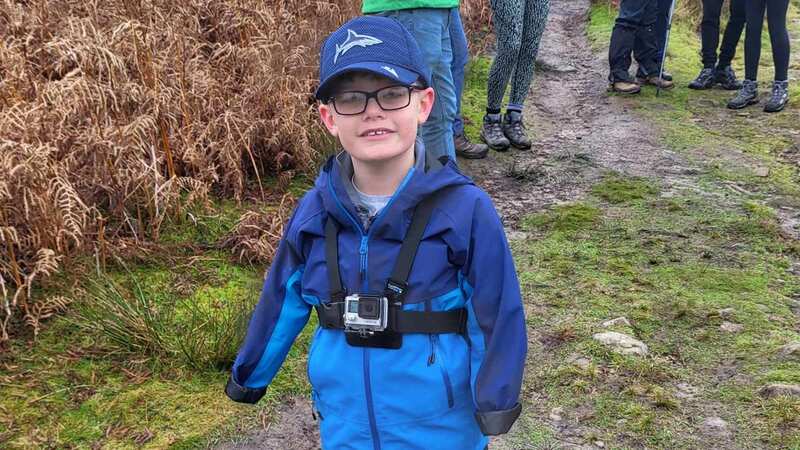 Luke Mortimer, 10, at the peak of Embsay Crag, North York on Saturday (Image: Adam Mortimer / SWNS)