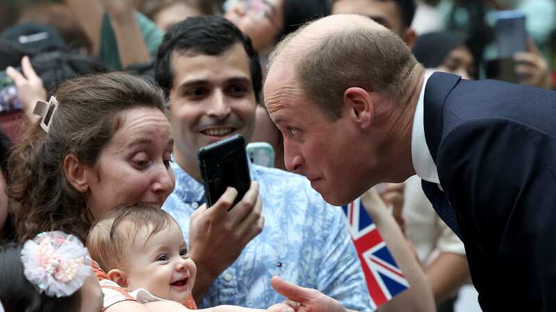 The baby grinned afterwards while William looked stunned and chatted to his mother (Image: Getty Images)