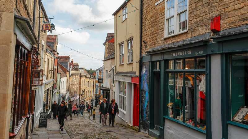 Pedestrians walk along the High Street in Frome (Image: Bloomberg via Getty Images)