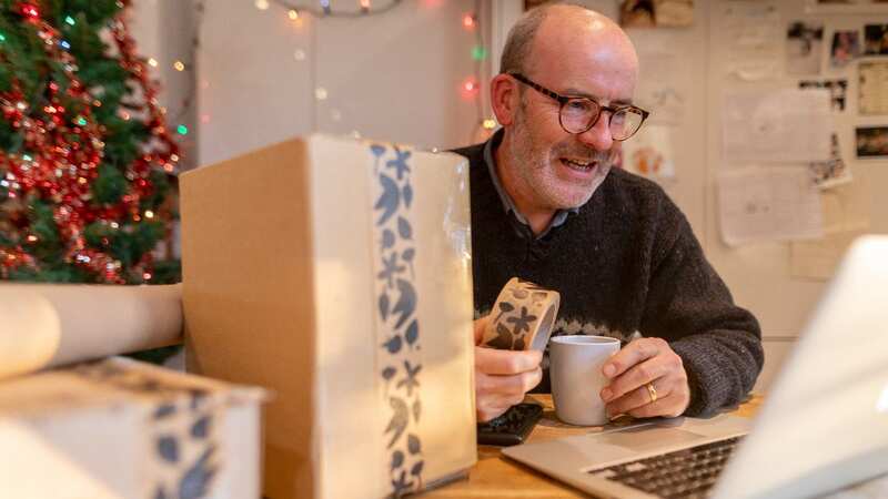 Man wrapping presents for Christmas (Image: Getty Images/Image Source)