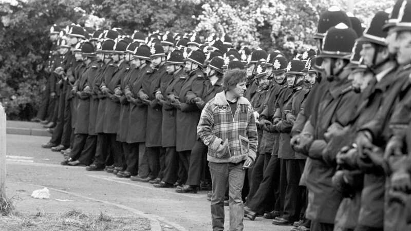 Picketer eyes police line at Orgreave in June 1984 (Image: PA)