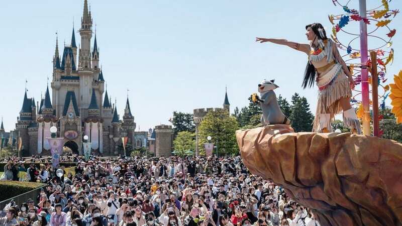 Staff were given fast-track passes so they could beat the queues at Tokyo Disneyland (Image: AFP via Getty Images)