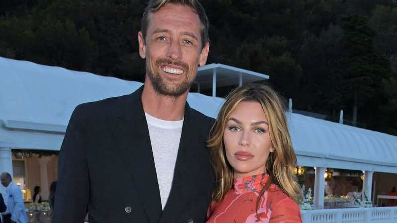 Abbey Clancy surprised Peter Crouch at work in nothing but a Burberry coat
