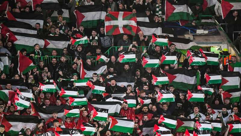 Celtic supporters hold Palestinian flags prior to the UEFA Champions League group E football match against Atletico Madrid.