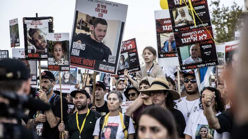Families of Israeli hostages held by Hamas in Gaza and anti-government protesters holding yellow balloons (Image: Anadolu via Getty Images)