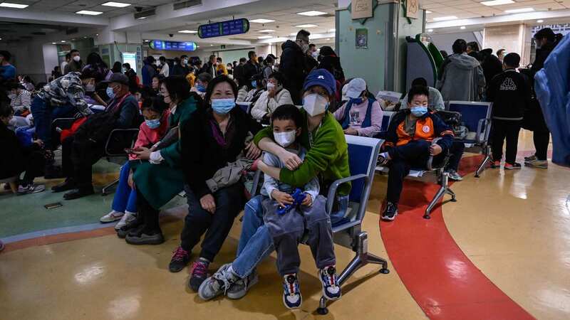 Children and their parents wait at a hospital in Beijing (Image: AFP via Getty Images)