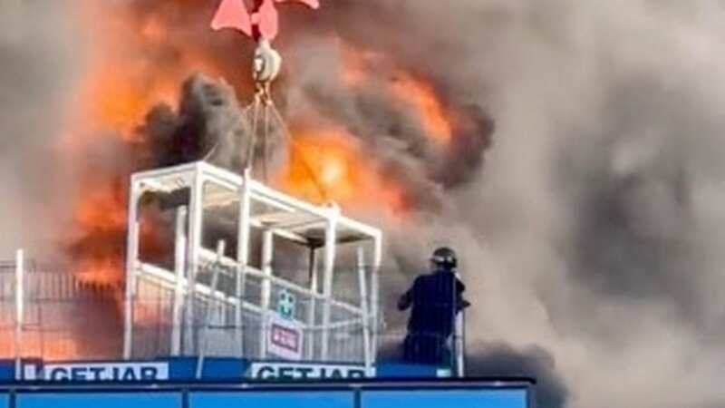 Incredible moment man rescued from top of burning tower block with crane