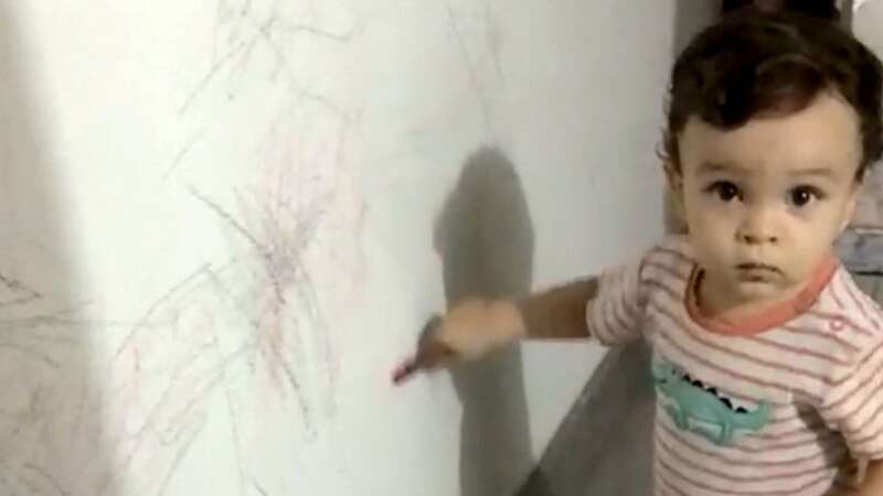 Santiago Daniel drawing on the walls at home when he was a toddler. (Image: Adianée Peña García / SWNS)