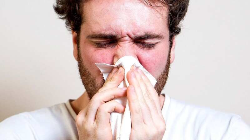 A stock image of a man suffering from flu (Image: SWNS)
