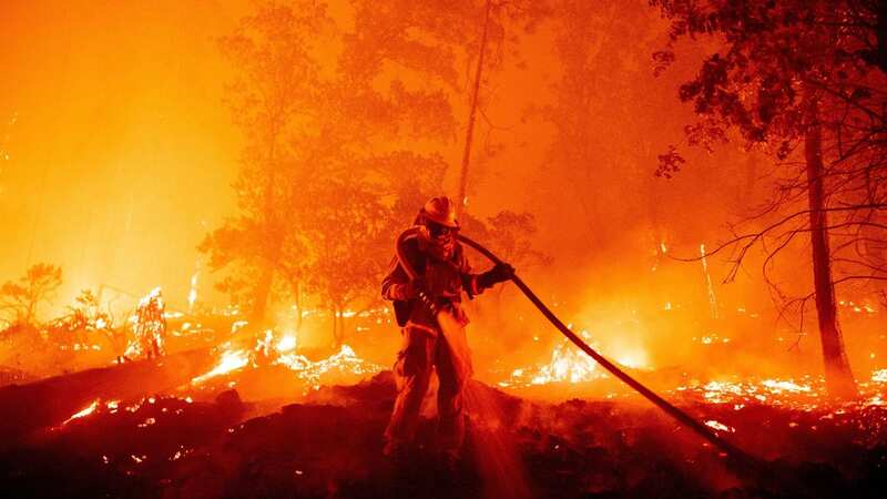 A firefighter douses flames in California (Image: AFP via Getty Images)