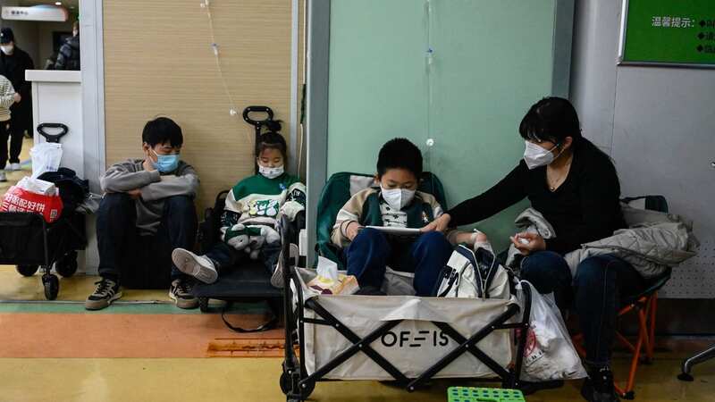 Children receive a drip at a children hospital in Beijing amid rising cases of a respiratory illness (Image: AFP via Getty Images)
