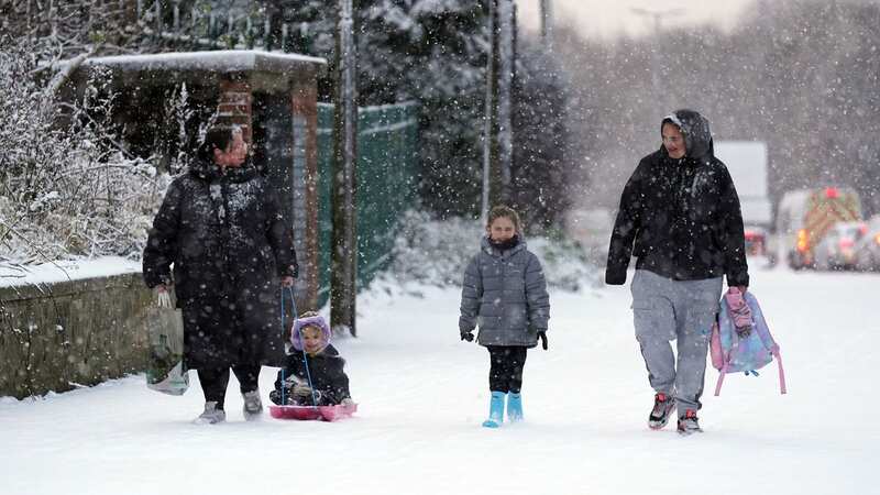 People are pictured in the snow in Gateshead, Tyne and Wear, today (Image: PA)