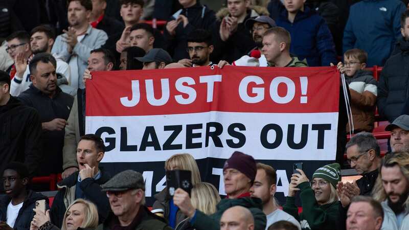 Manchester United fans hold up a banner saying 
