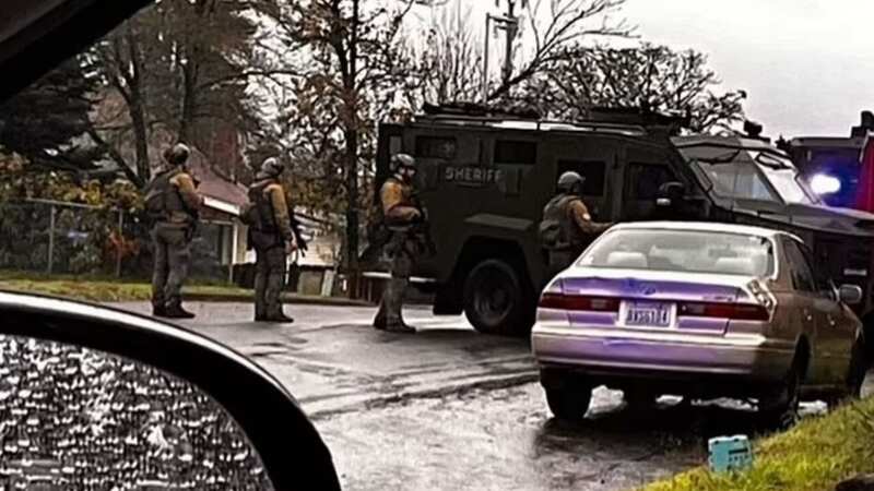 A huge police presence rushed to the home amid reports of multiple shootings (Image: KPTV Fox12)