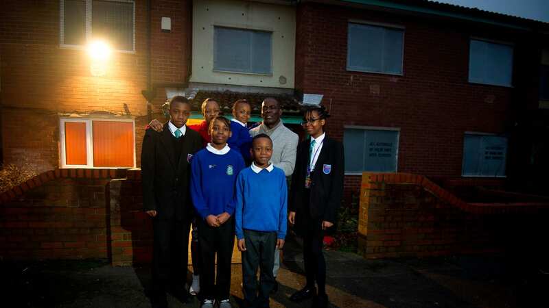 Demonique Wilson with his wife and children outside their home in Salford, Greater Manchester (Image: Manchester Evening News)