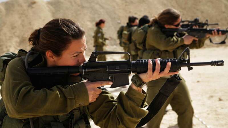 Female Israeli combatants fire rifles at a shooting range in Ein Yahav, southern Israel (Image: AFP via Getty Images)