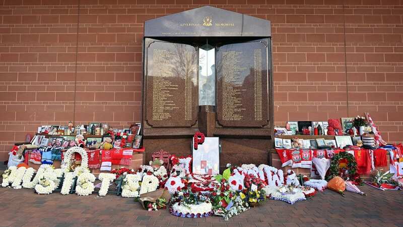 Flowers, shirts and photographs surround the eternal flame of the Hillsborough memorial at Anfield in Liverpool (Image: AFP via Getty Images)