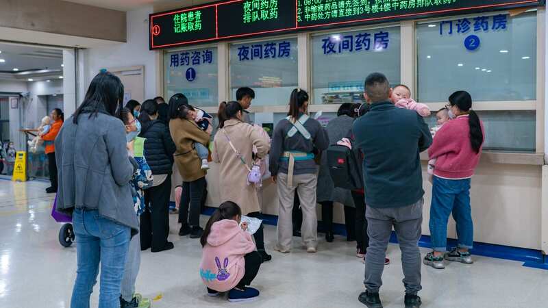 Parents with children suffering from respiratory diseases line up at a hospital in Chongqing, China (Image: Costfoto/NurPhoto/REX/Shutterstock)