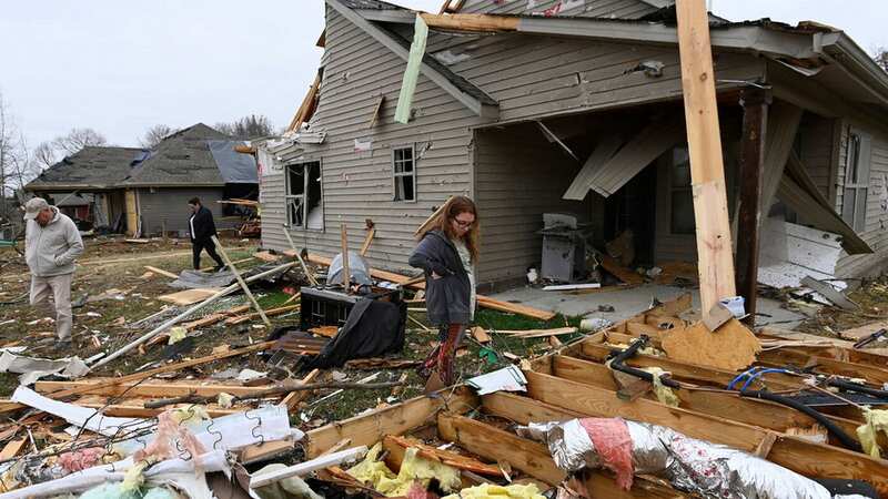 Jennifer Ricer looks for her belongings in the rubble of her home (Image: AP)