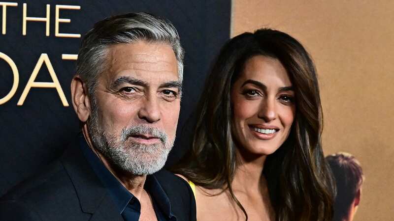 George Clooney says he has gotten used to playing second fiddle to his glamorous wife Amal