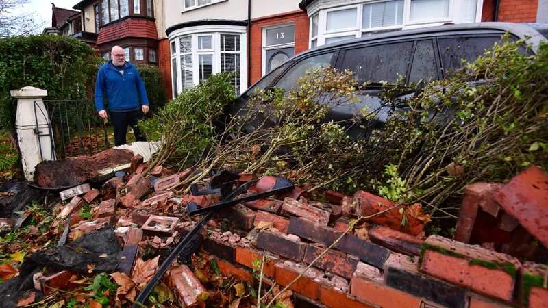 Darren Smith looks at the damage after a car crashed into his family home (Image: Liverpool Echo)
