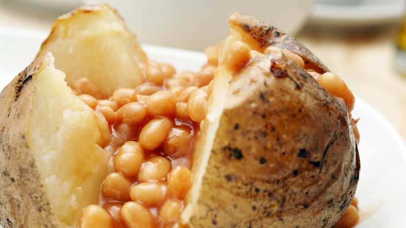 Baked beans are often enjoyed on a crispy jacket potato (Image: Getty Images)