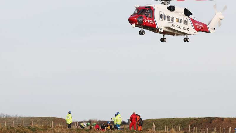 Rescue operation launched after man drops down 20ft cliff face as three arrested
